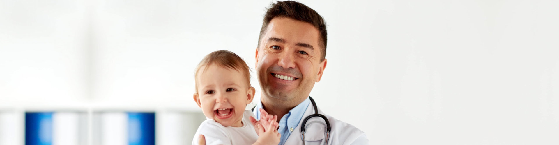 pediatrician holding a baby