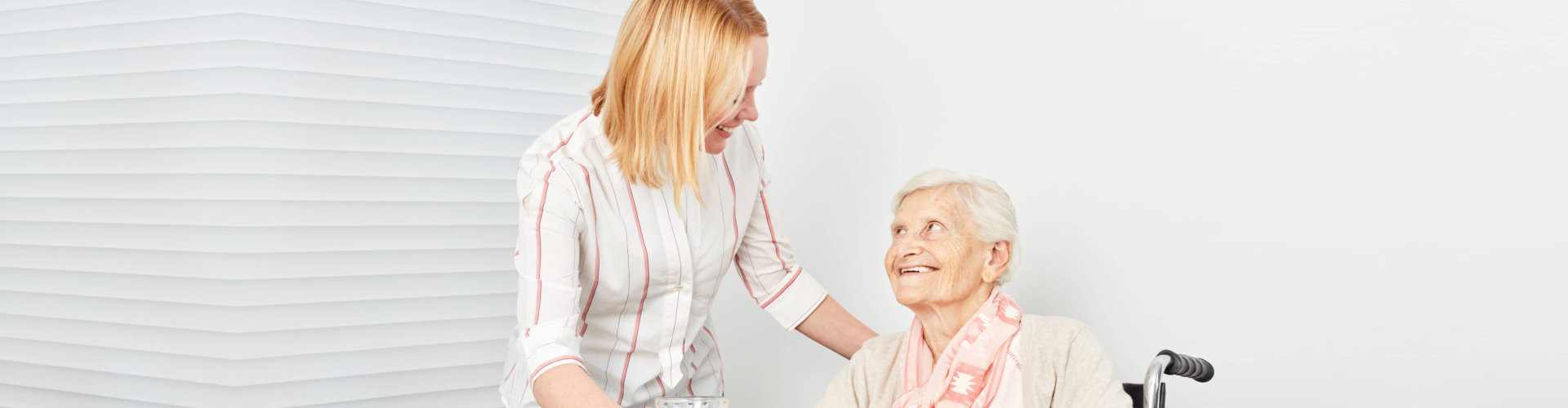 caregiver smiling to a senior woman